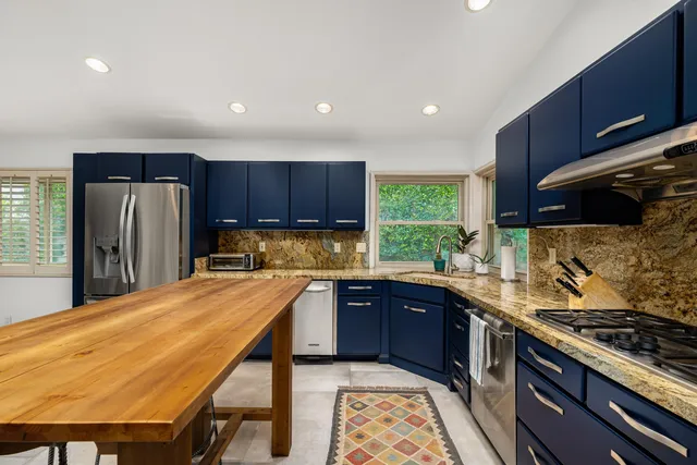a kitchen with wooden cabinets and stainless steel appliances