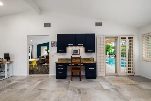 a view of kitchen and kitchen with furniture and large window