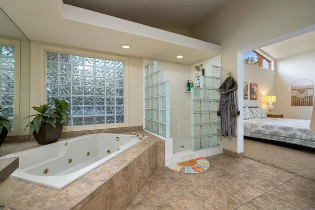 a bathroom with a tub a sink and shower