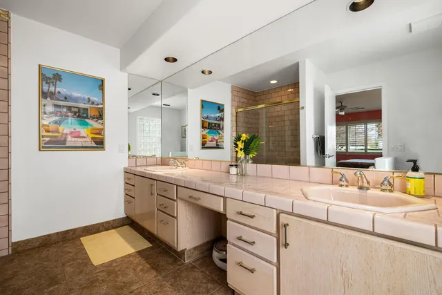 a bathroom with a sink double vanity granite and a mirror
