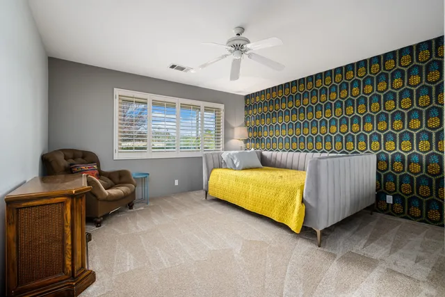 a bedroom with a bed and a couch