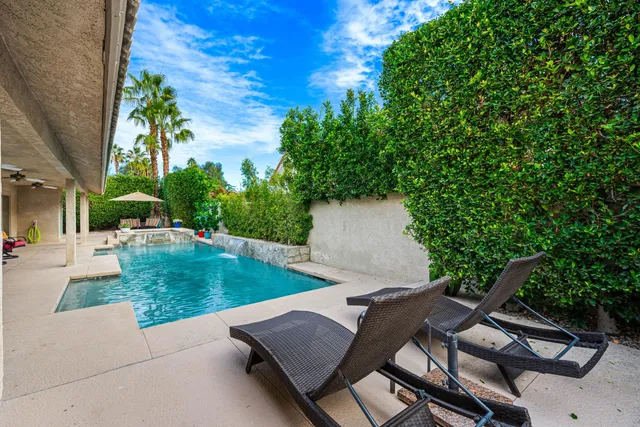 a view of backyard with swimming pool