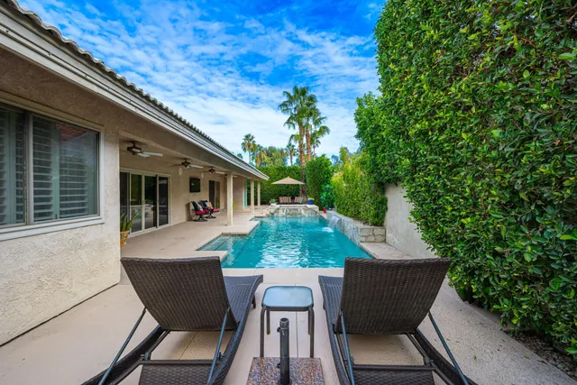 a view of backyard of house with seating space
