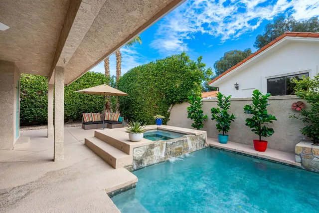 a view of a backyard with plants and patio