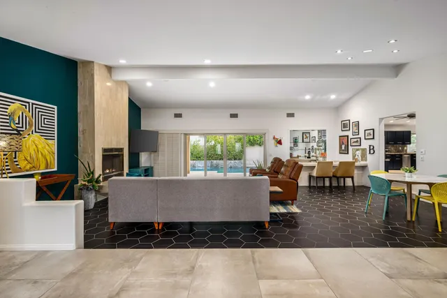 a living room with furniture large window and flat screen tv