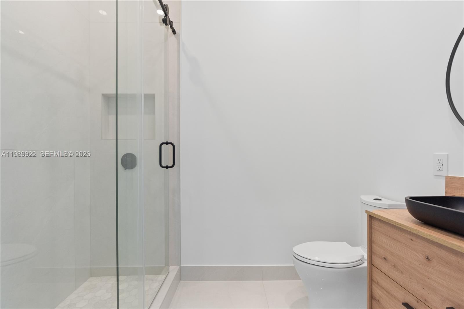6221 Southwest 60th Street South Miami, FL 33143 - Photo 29 of 42 a bathroom with a granite countertop toilet and a shower