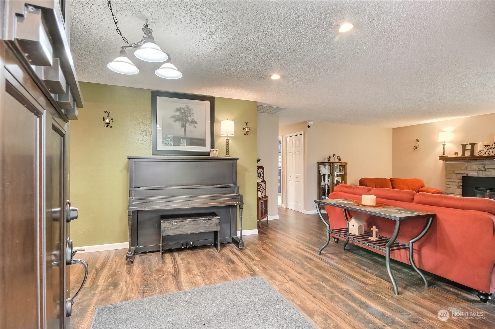 18623 Joselyn Road Southwest Rochester, WA 98579 - Photo 8 of 40 a living room with furniture a piano and wooden floor