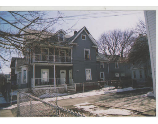 a view of a brick house with large windows