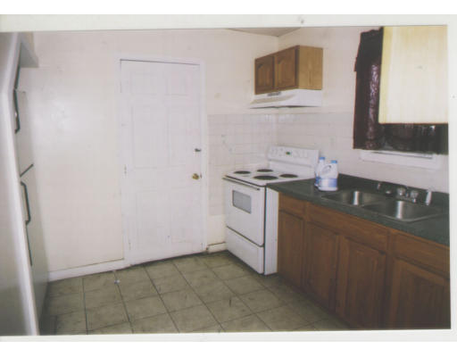 9 Lander Street Lynn, MA 01902 - Photo 2 of 4 a kitchen with sink cabinets and stove