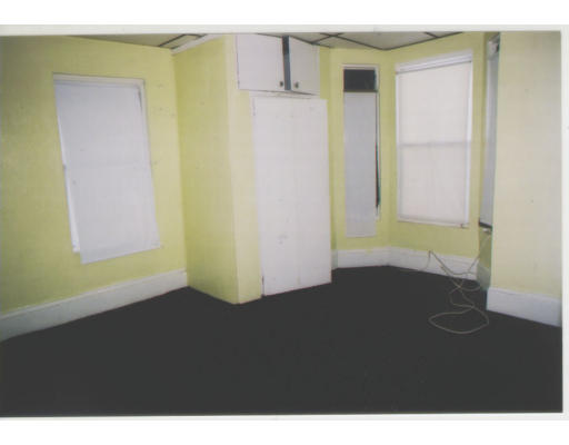 9 Lander Street Lynn, MA 01902 - Photo 4 of 4 a view of an empty room with wooden floor and a window