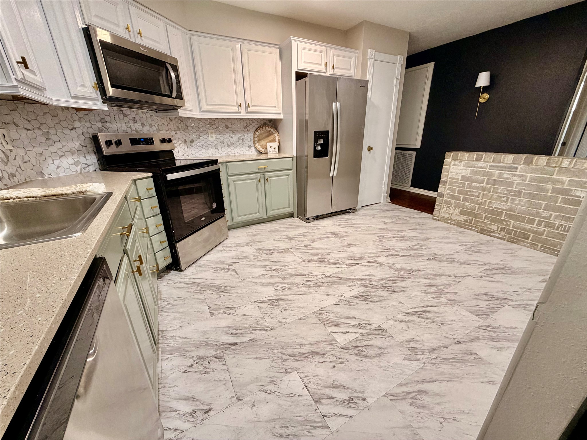 4506 Pineville Lane Spring, TX 77388 - Photo 16 of 33 a kitchen with a refrigerator sink and microwave