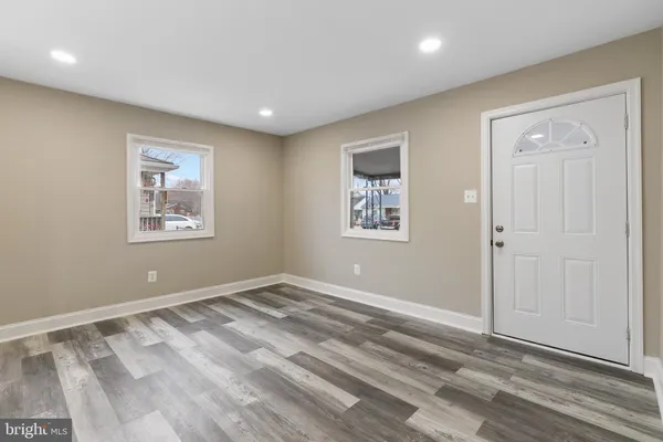 a view of room with window and wooden floor