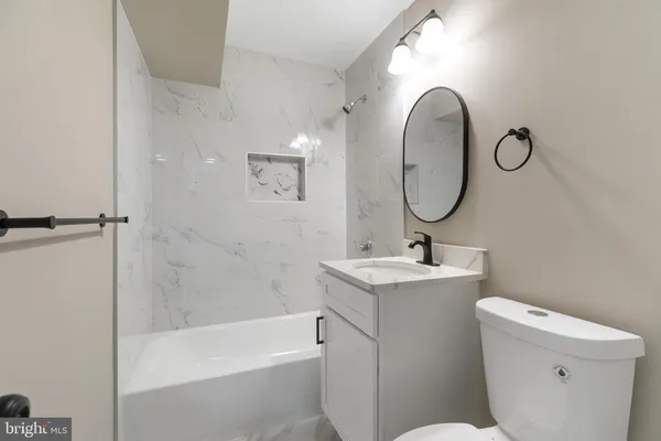 a bathroom with a sink toilet and a mirror