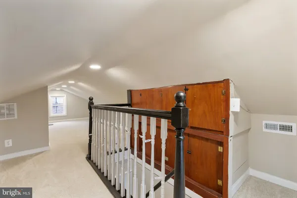 a view of hallway with wooden floor