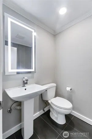 a white toilet sitting next to a bathroom sink
