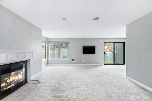 a view of empty room with a fireplace
