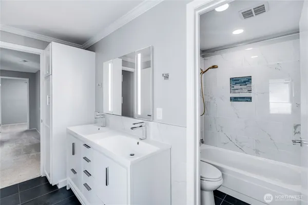 a bathroom with a shower a toilet and a shower