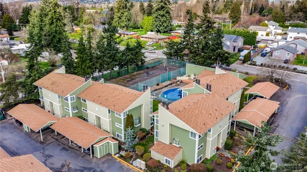 an aerial view of residential houses with outdoor space and swimming pool