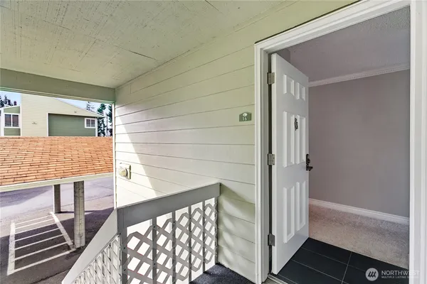 a view of a hallway to a livingroom with furniture
