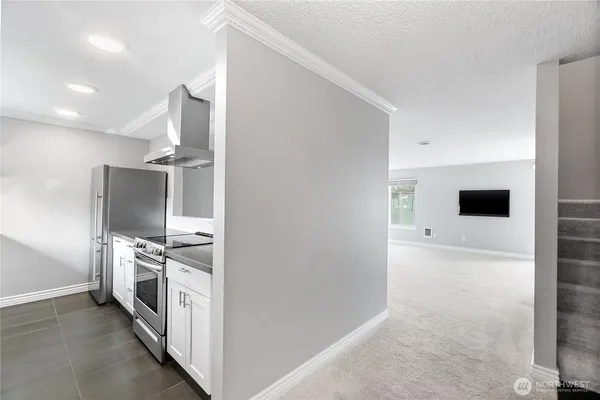 a kitchen with a sink and stainless steel appliances