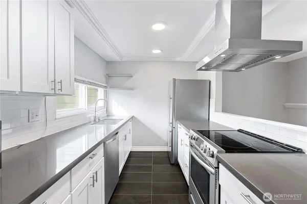 a kitchen with a stove and a refrigerator