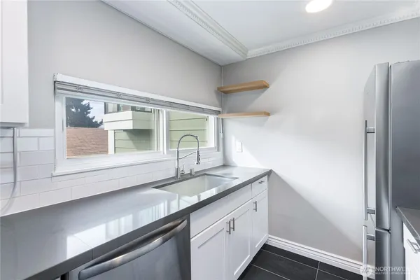 a kitchen with a sink and a refrigerator