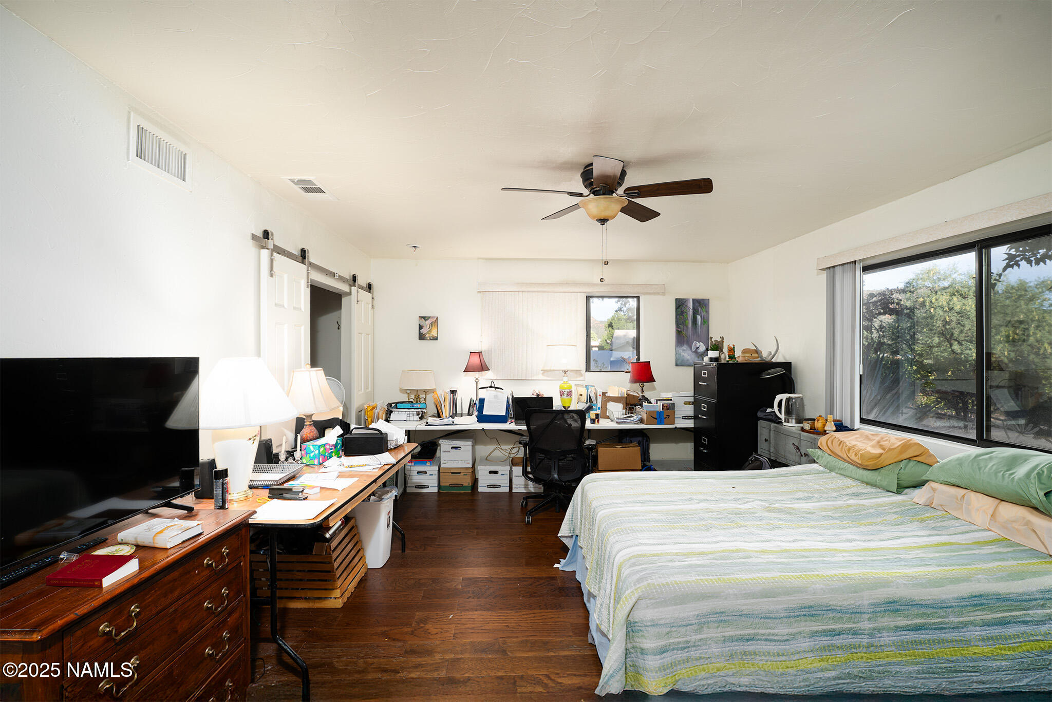 90 Vultee Road Sedona, AZ 86351 - Photo 14 of 25 a bed room with a bed a television and a large window