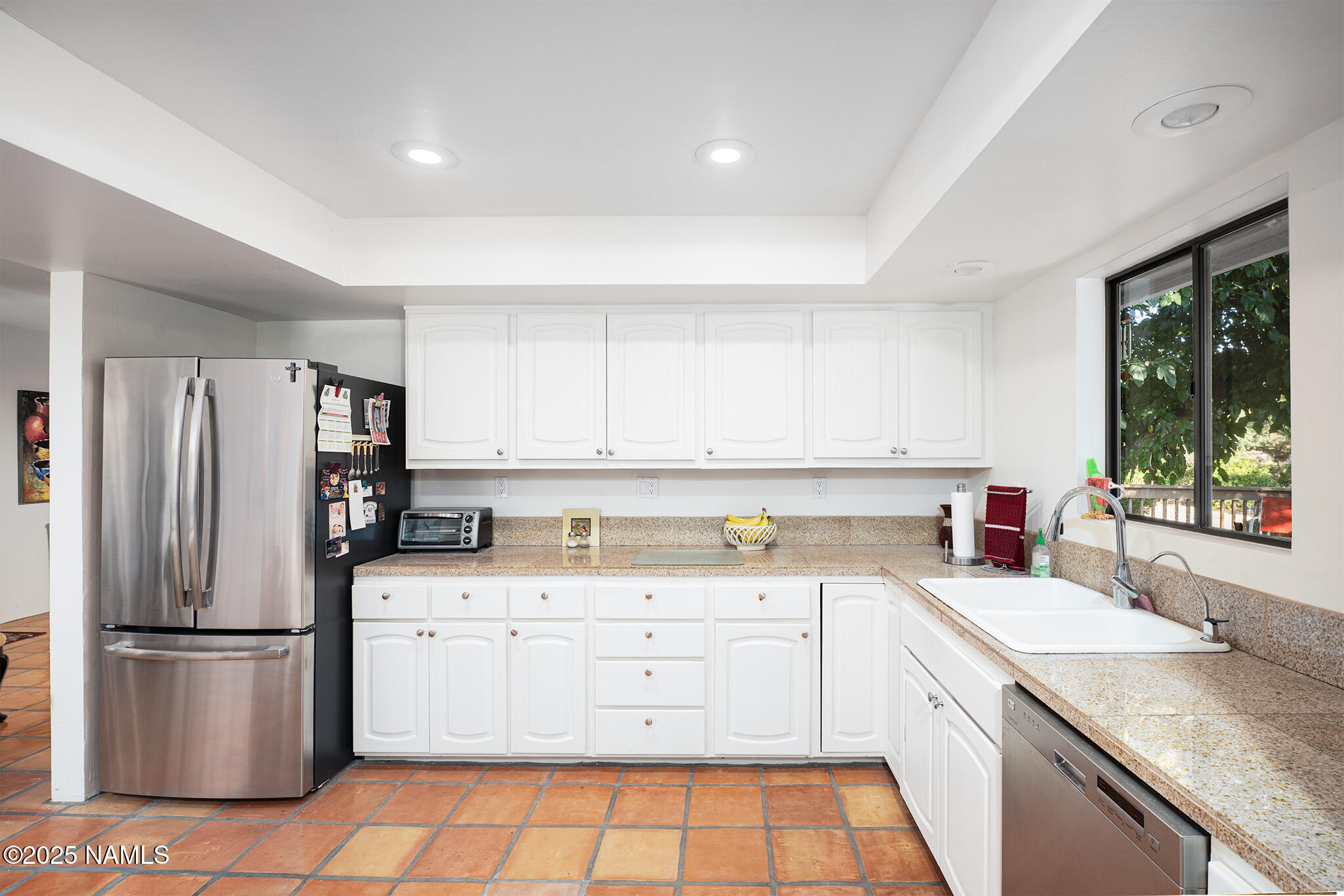 90 Vultee Road Sedona, AZ 86351 - Photo 5 of 25 a kitchen with a sink a refrigerator a window and cabinets