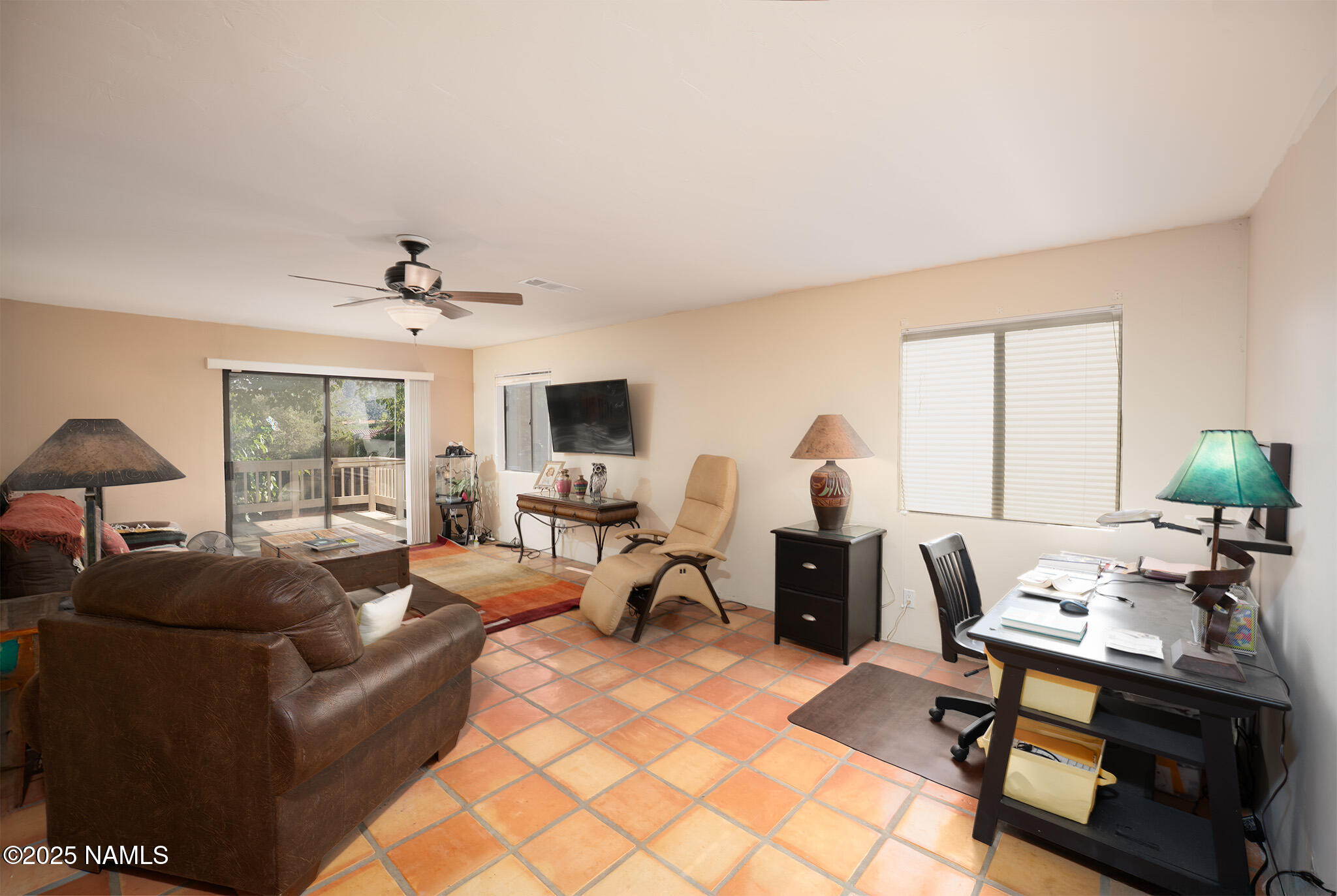 90 Vultee Road Sedona, AZ 86351 - Photo 9 of 25 a living room with furniture a chandelier and a flat screen tv