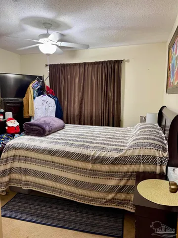 a bedroom with a large bed and a window