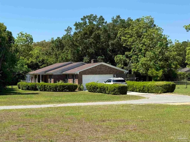 a front view of house with yard and green space
