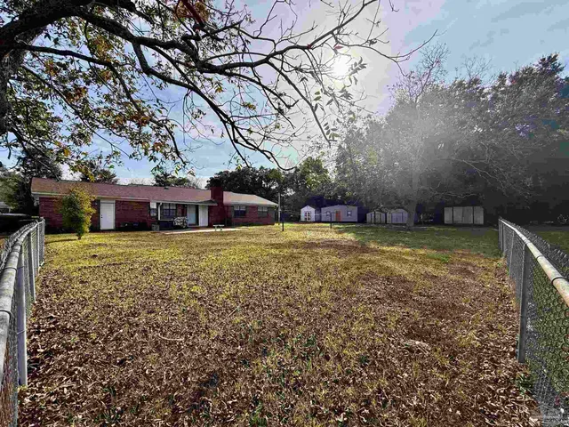 a view of house with backyard
