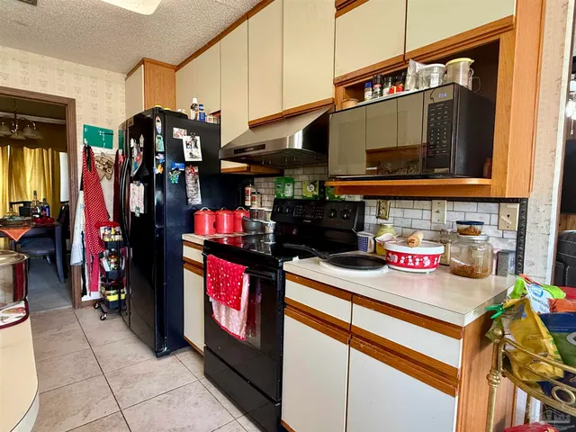 a kitchen with stainless steel appliances granite countertop a stove and a microwave