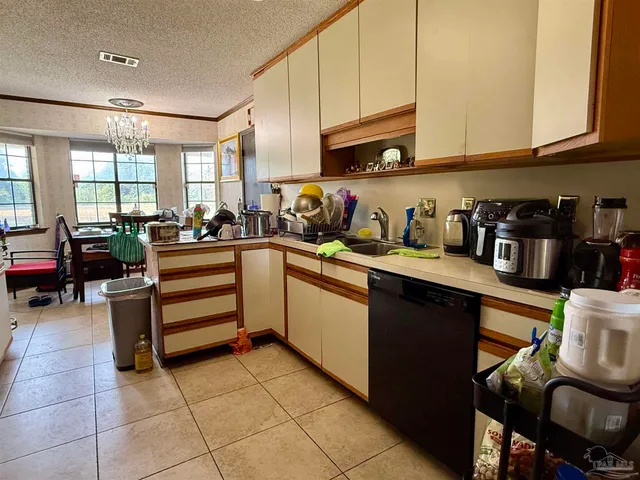 a kitchen with a sink a stove and cabinets