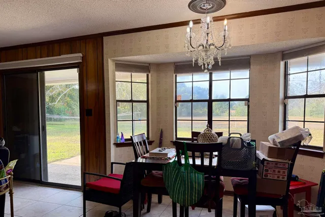 a view of a dining room with furniture window and outside view