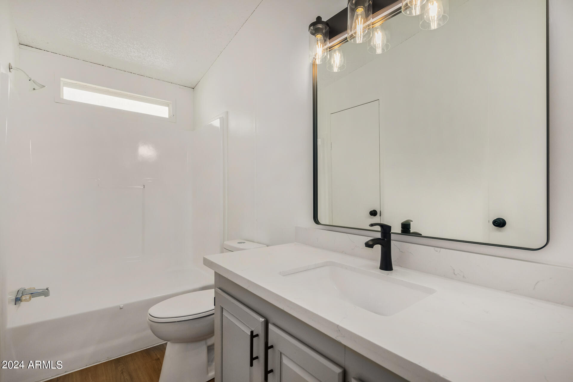 355 North Conejo Road Maricopa, AZ 85139 - Photo 14 of 30 a bathroom with a sink a toilet and a mirror