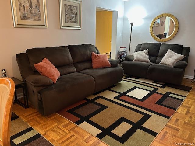 a living room with furniture and a mirror