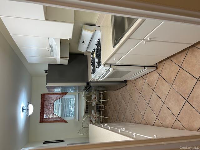 450 Pelham Road, Unit 1B New Rochelle, NY 10805 - Photo 8 of 10 a kitchen with stainless steel appliances a stove a sink and a refrigerator