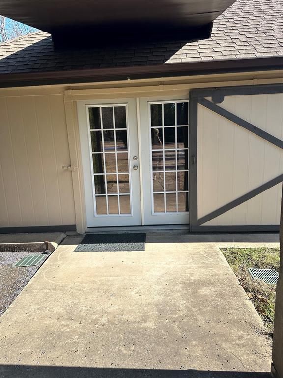 2590 Rock Ridge Road Lucas, TX 75002 - Photo 1 of 25 Double paneled glass doors with grid inserts, set against a light-colored exterior wall