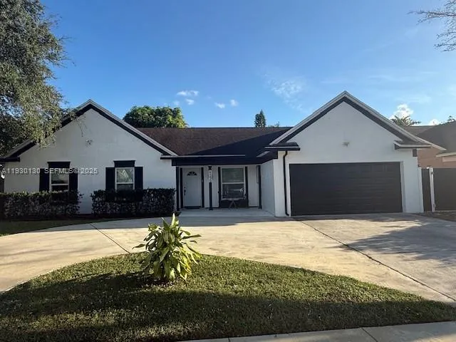 a front view of a house with yard and garage