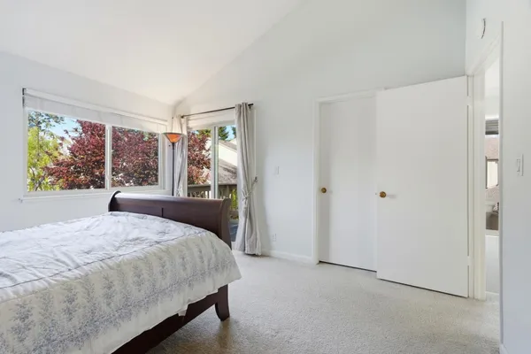 a bedroom with a large bed and a window