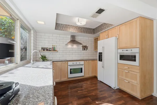 a kitchen with stainless steel appliances a refrigerator sink and stove