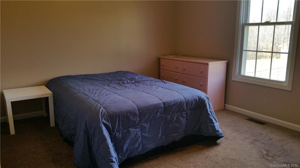 1348 Lawrence Road Clover, SC 29710 - Photo 15 of 21 a bed sitting in a bedroom next to a window