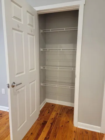 a view of walk in closet with empty racks