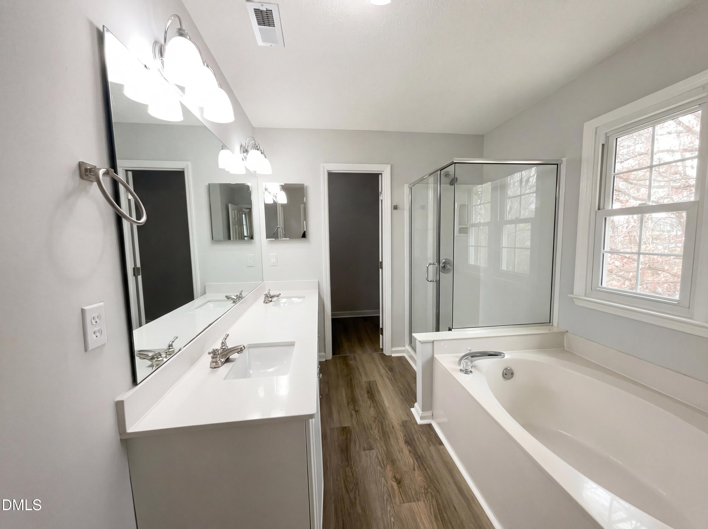 12213 Freemont Lane Raleigh, NC 27613 - Photo 11 of 19 a bathroom with a tub sink and mirror