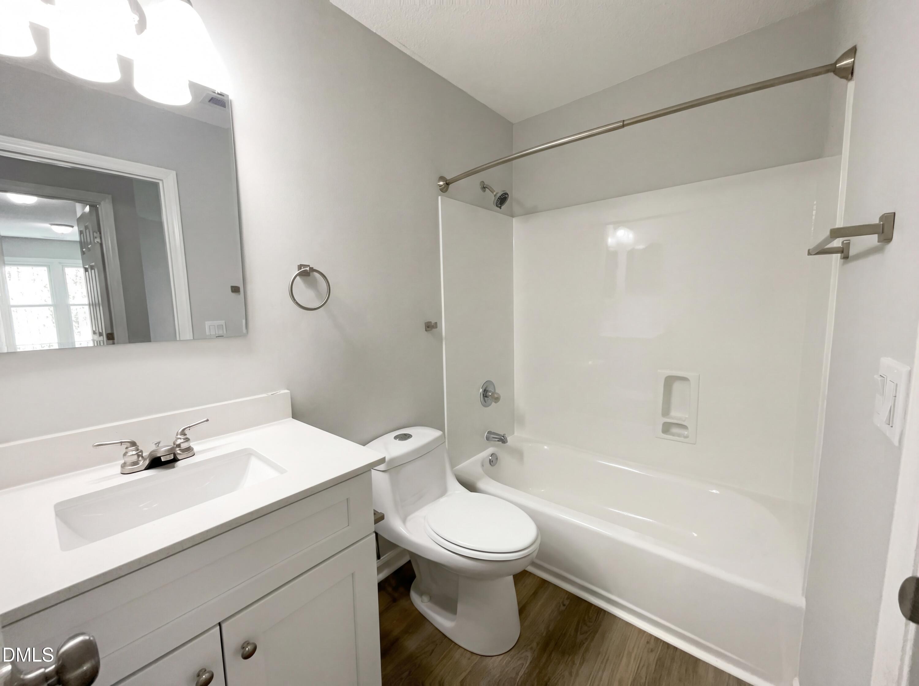 12213 Freemont Lane Raleigh, NC 27613 - Photo 12 of 19 a bathroom with a sink toilet a mirror and shower