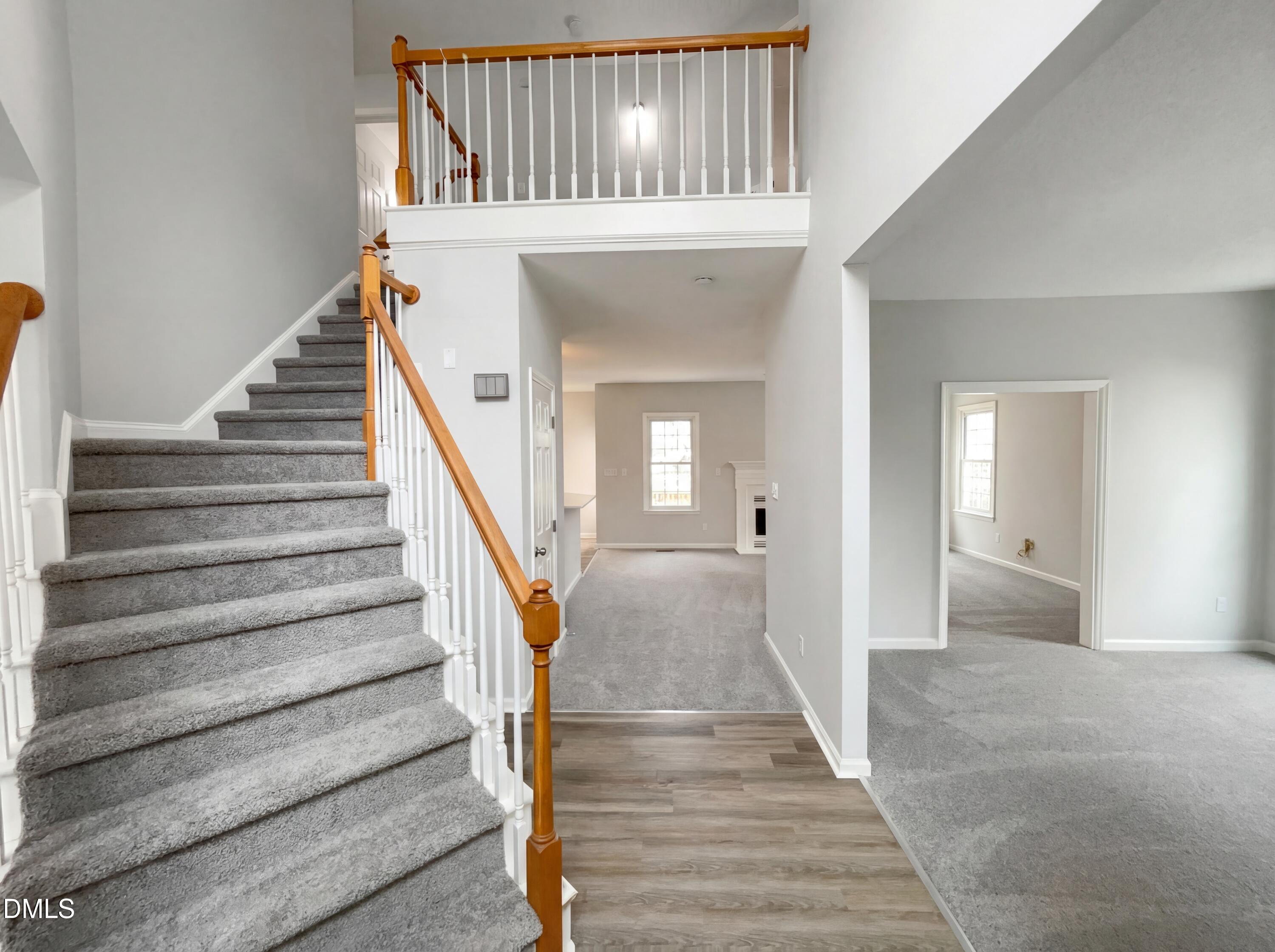 12213 Freemont Lane Raleigh, NC 27613 - Photo 6 of 19 a view of staircase with white walls and railing