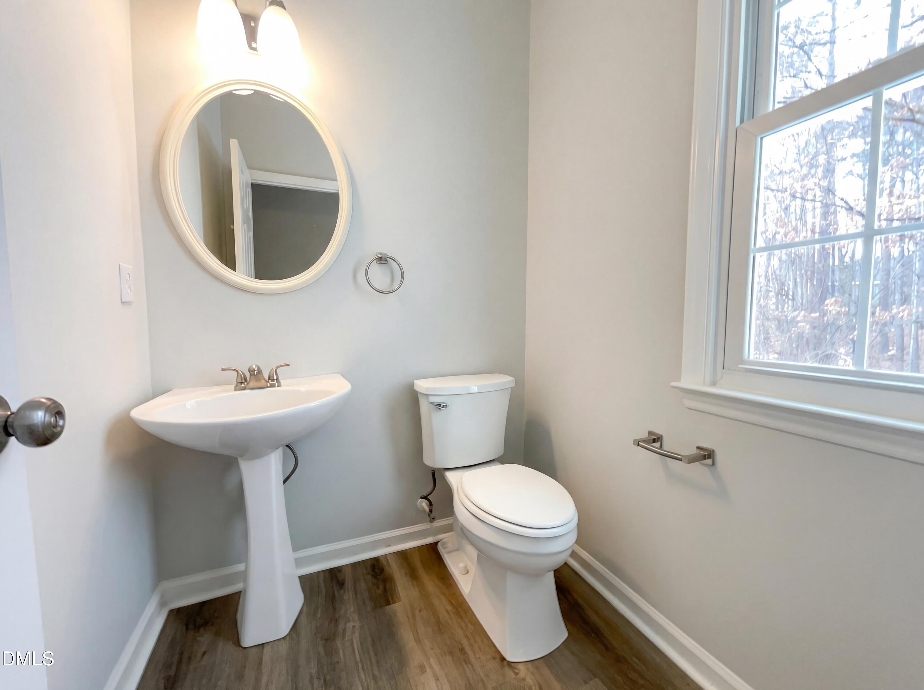 12213 Freemont Lane Raleigh, NC 27613 - Photo 8 of 19 a bathroom with a sink toilet and a mirror