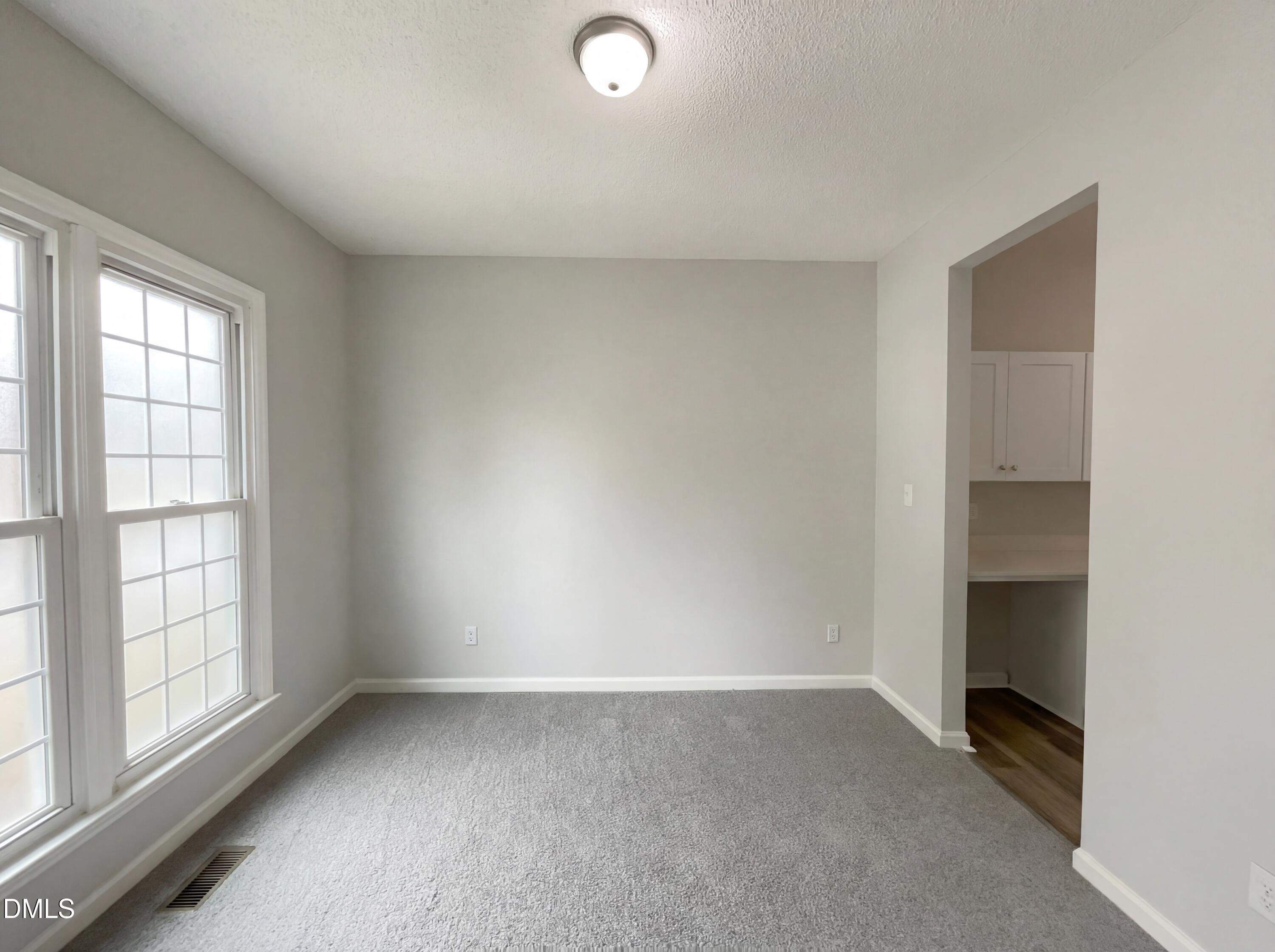 12213 Freemont Lane Raleigh, NC 27613 - Photo 9 of 19 an empty room with a empty space and window