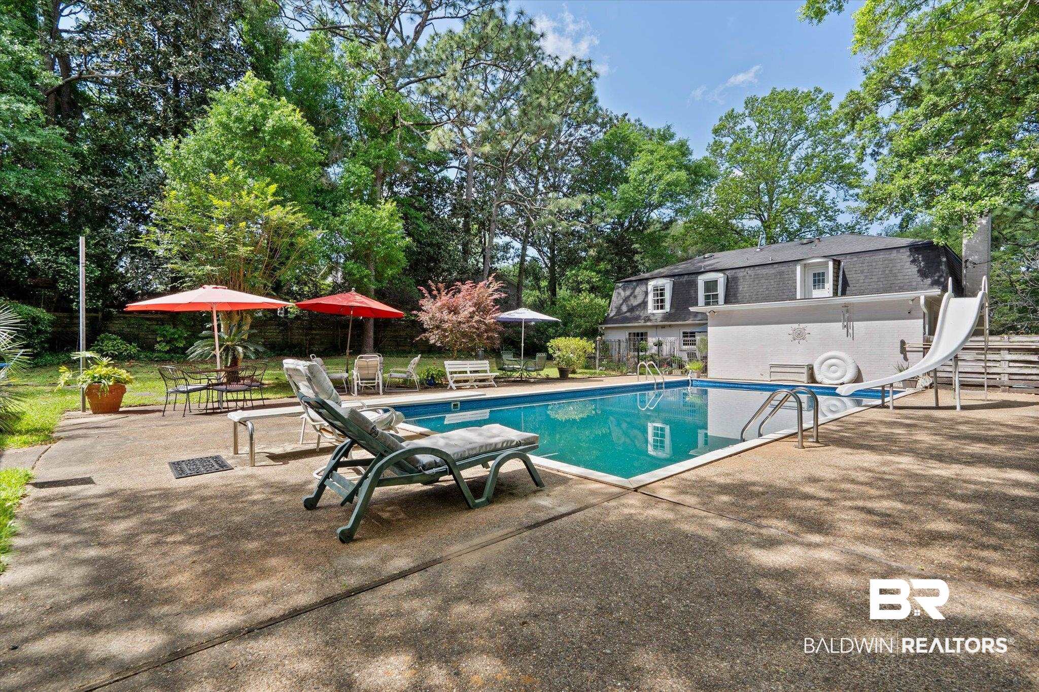 559 East Cumberland Road Mobile, AL 36608 - Photo 34 of 48 Outdoor pool with a patio, a water slide, and view of scattered trees